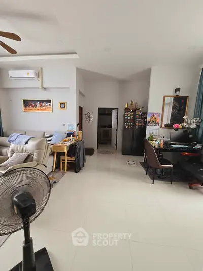 Spacious living room with modern decor and open layout, perfect for family gatherings.