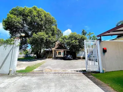 Charming house with spacious driveway and lush greenery in a serene neighborhood.