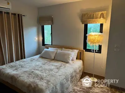 Cozy bedroom with plush bedding and ambient lighting