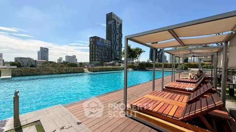 Luxurious rooftop pool with modern cityscape views and elegant sun loungers.