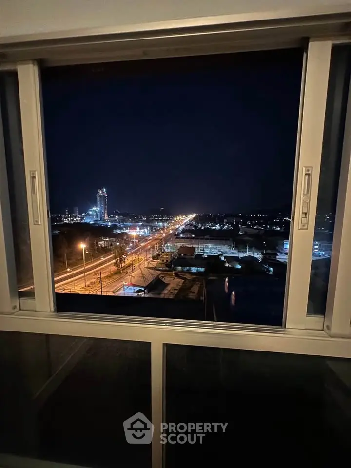 Stunning night cityscape view from a high-rise apartment window.