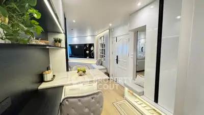 Modern living room with stylish decor and open layout, featuring cozy seating and elegant shelving.