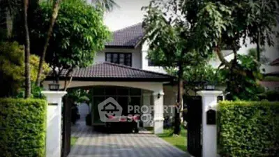 Charming suburban house with lush garden and gated entrance