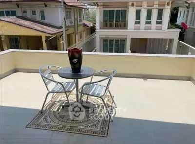 Spacious balcony with modern patio furniture and scenic neighborhood view.