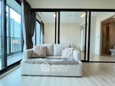 Spacious living room with large windows and balcony access in modern apartment