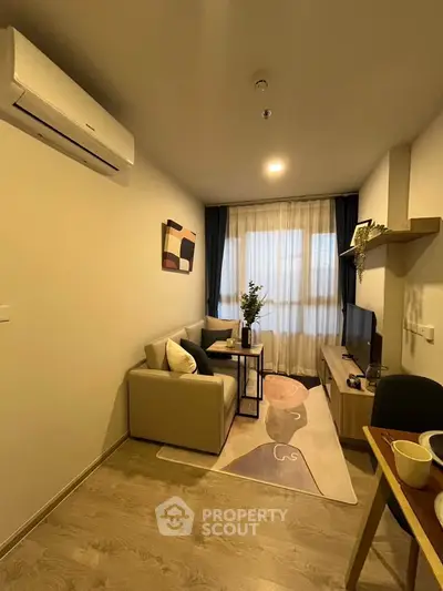 Cozy modern living room with stylish decor and natural light, perfect for relaxation and entertainment.