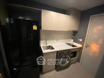 Modern kitchen with sleek appliances and compact design