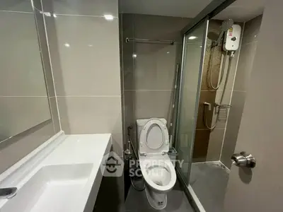 Modern bathroom with sleek fixtures and glass shower enclosure