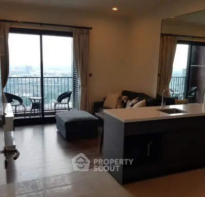 Modern open-layout living room with kitchen and balcony view