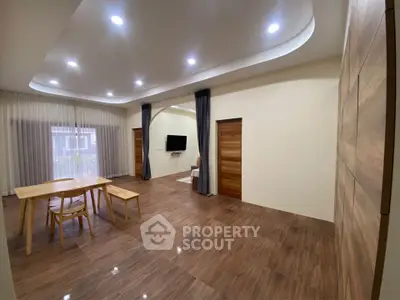 Spacious modern living room with wooden flooring and elegant lighting