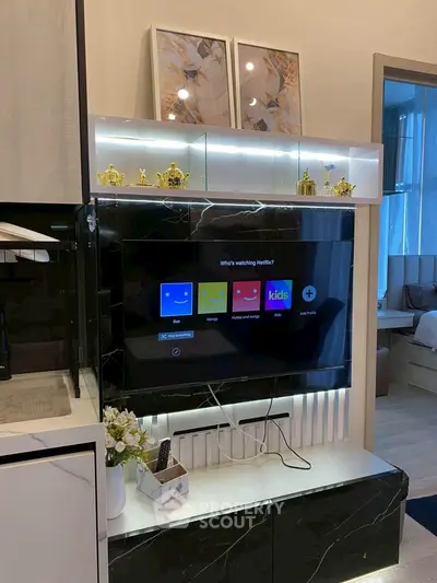 Modern living room with sleek TV setup and decorative accents