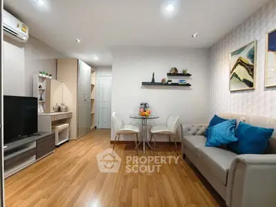 Modern living room with stylish decor, wooden flooring, and cozy seating area.