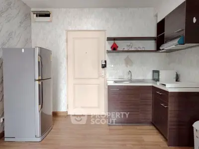 Modern kitchen with sleek cabinets and stainless steel appliances in a stylish apartment.