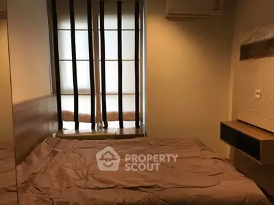 Cozy bedroom with modern design and natural light through stylish window blinds.