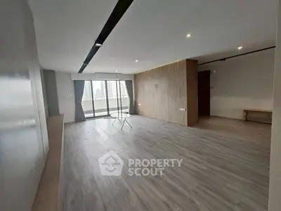 Spacious modern living room with large windows and city view