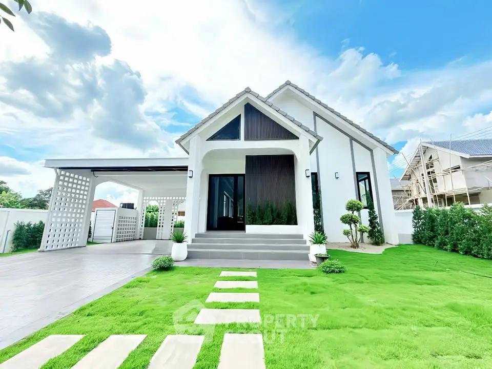 Charming modern house with lush green lawn and spacious driveway, perfect for family living.