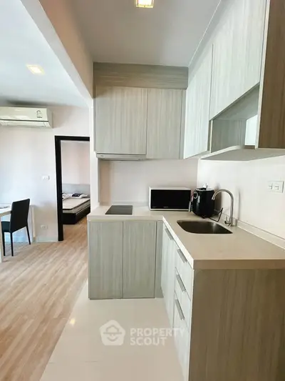 Modern kitchen with sleek cabinetry and integrated appliances in a stylish apartment.