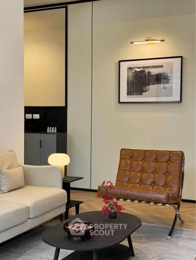 Modern living room with stylish furniture and contemporary art on the wall.