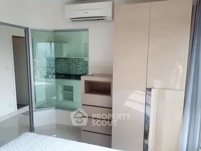 Modern bedroom with sleek wardrobe and city view window