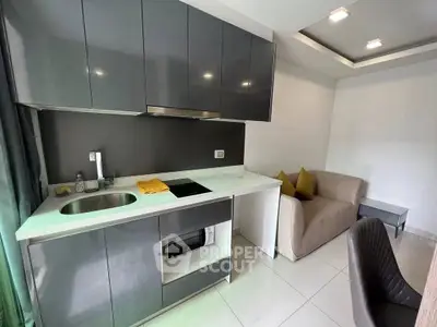 Modern compact kitchen with sleek cabinets and cozy seating area, perfect for urban living.
