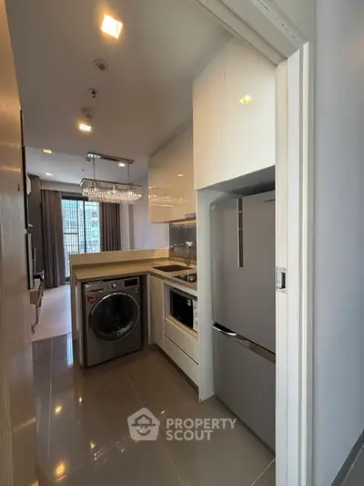 Modern kitchen with sleek appliances and open layout in a stylish apartment