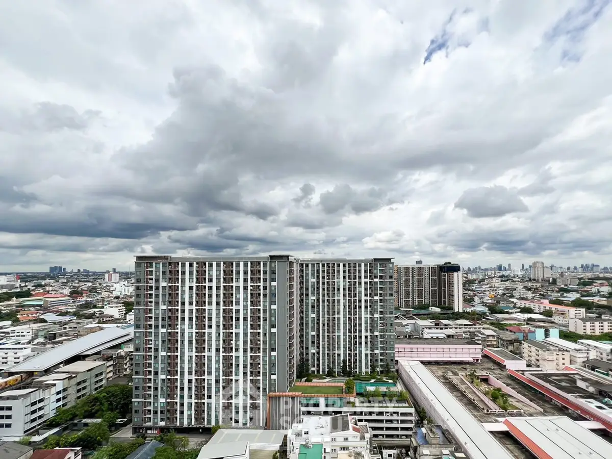 Stunning cityscape view of modern high-rise buildings under dramatic cloudy sky.