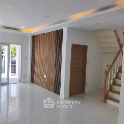 Modern interior with sleek staircase and elegant flooring in a bright living space.