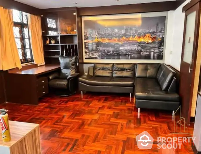 Spacious living room with polished parquet flooring, luxurious leather sofa, and a captivating cityscape wall mural.