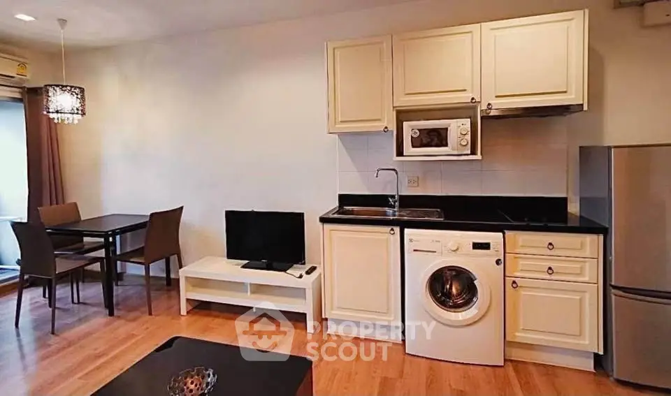 Charming open-layout kitchen with modern appliances and cozy dining area, perfect for urban living.