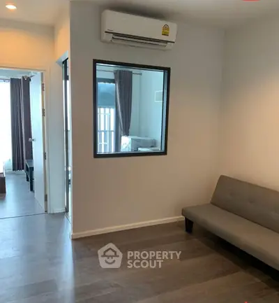 Modern apartment interior with sleek flooring and air conditioning unit