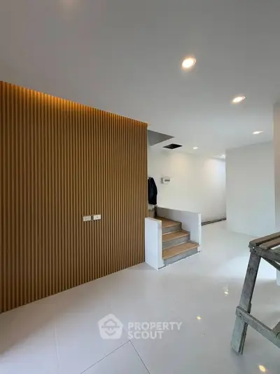 Modern interior with sleek staircase and stylish wood paneling
