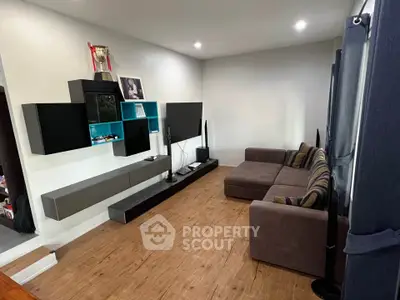 Modern living room with stylish furniture and entertainment center, perfect for relaxation and entertainment.