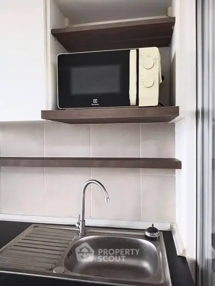 Modern kitchen with microwave and sleek sink design