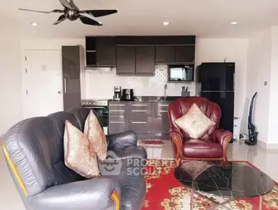Stylish living room with modern kitchen, leather sofas, and elegant decor in open-plan apartment.