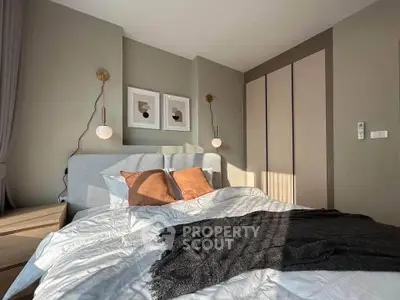 Cozy modern bedroom with stylish decor and ample natural light