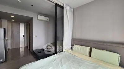 Modern bedroom with air conditioning and sliding glass door in a stylish apartment.