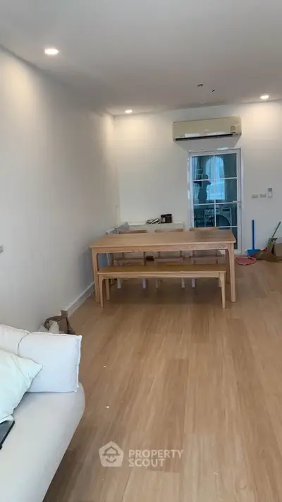 Spacious living room with wooden flooring and modern furniture