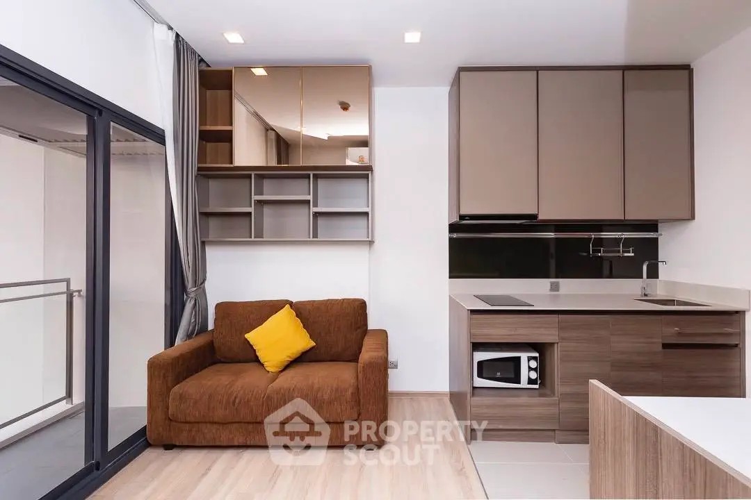 Modern studio apartment with cozy living area and sleek kitchen design