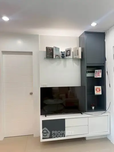 Modern living room with sleek TV unit and stylish shelving