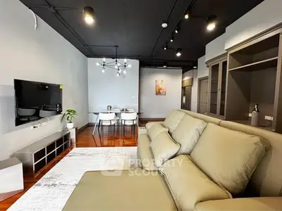 Modern living room with stylish furniture and elegant lighting, perfect for contemporary living.