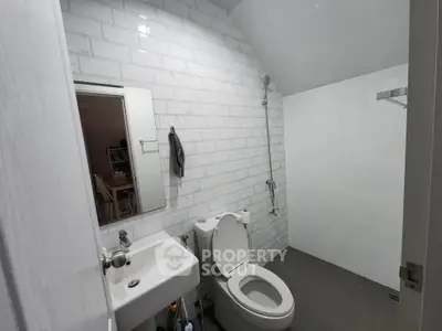 Modern bathroom with sleek white tiles and contemporary fixtures