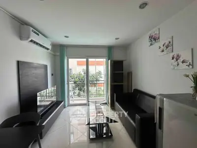 Modern living room with sleek furniture and balcony view, perfect for urban living.