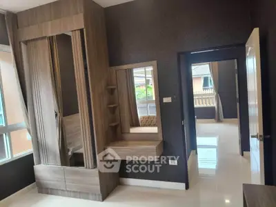 Modern bedroom with stylish wooden wardrobe and vanity in a bright, spacious interior.