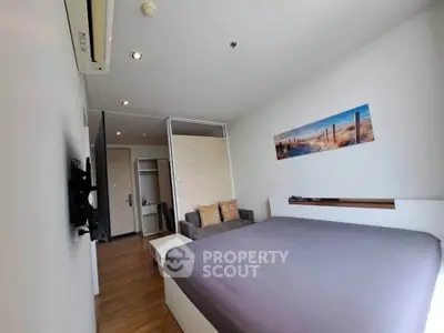 Modern bedroom with stylish decor and cozy ambiance in a contemporary apartment.