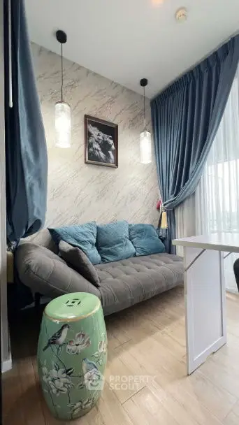 Chic living room with plush sofa, elegant curtains, and stylish decor in modern apartment.