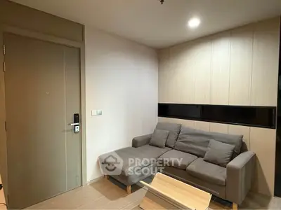 Cozy living room with modern sofa and wooden accents, perfect for relaxation.