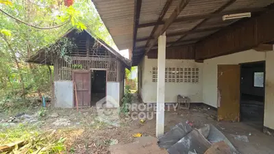 Explore potential in this rustic property with spacious outdoor area and unique architectural features.