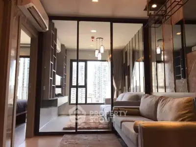 Modern living room with large windows and city view, featuring a cozy sofa and elegant decor.