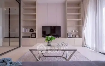 Modern living room with elegant decor and large windows offering natural light.