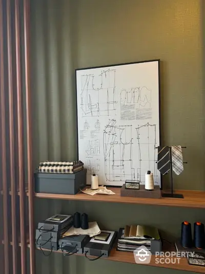 Stylish home office with sewing supplies and framed fashion sketches on wall